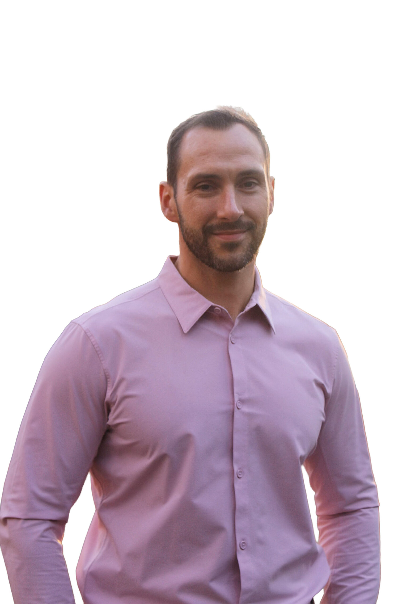 Michael Bugary smiling in a light pink dress shirt, standing against a bright neutral background.